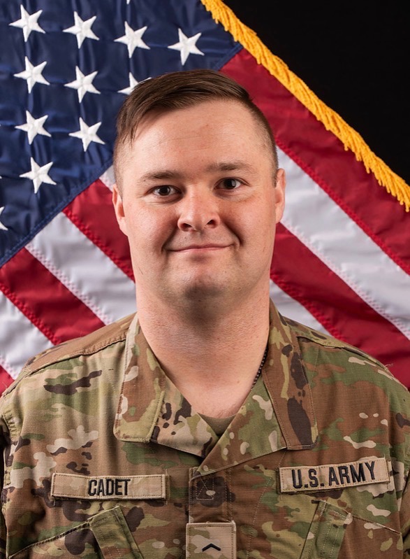 author in military uniform with United States flag behind